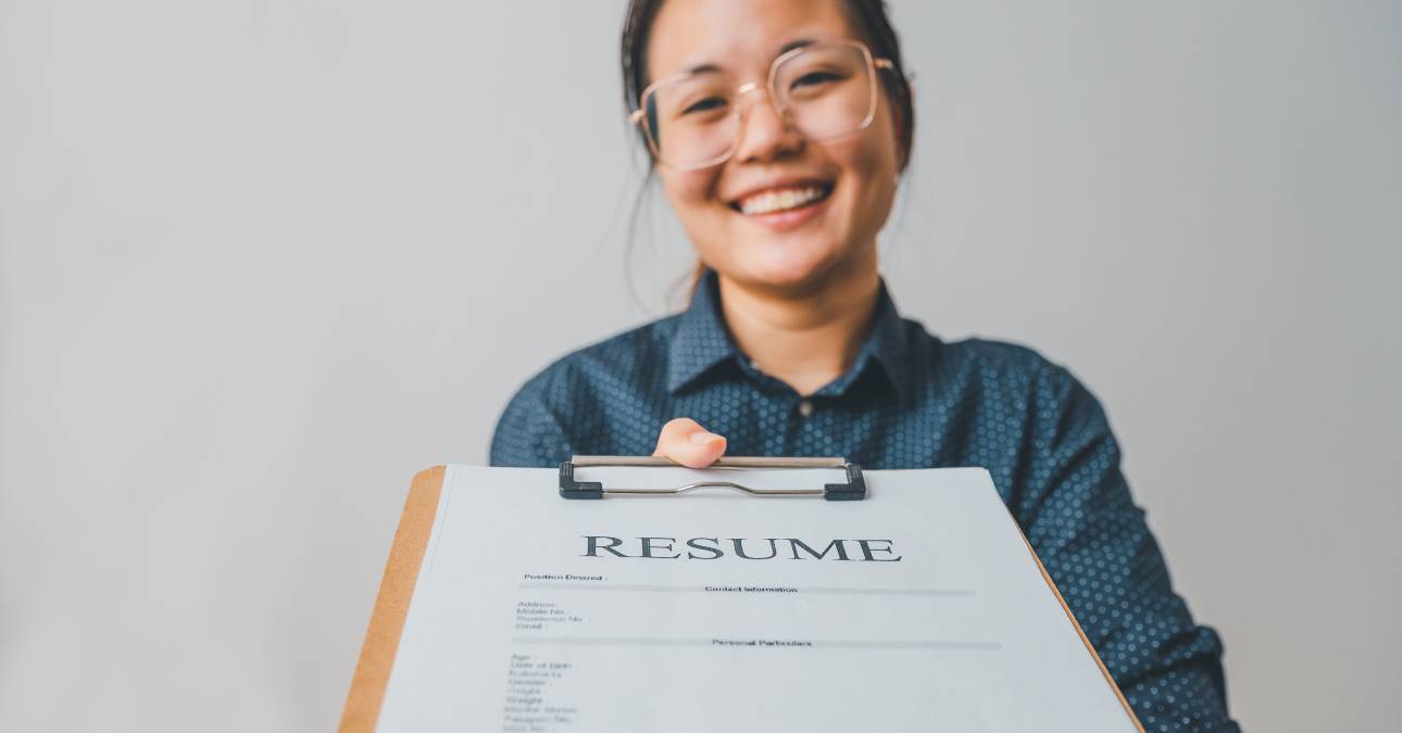 Woman holding clipboard with resume